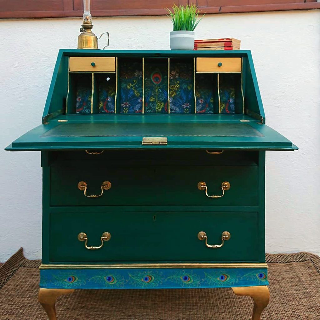 Beautiful 1930's Bureau which was commissioned to feature a custom turquoise colour and Emma J Shipley wallpaper as a detail.
There was a hand- painted peacock feather to the front and Peacock themed ribbon. Gold Legs and a new Leather writing insert were also incorporated